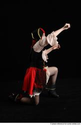 DARINA KNEELING POSES WITH DAGGER 